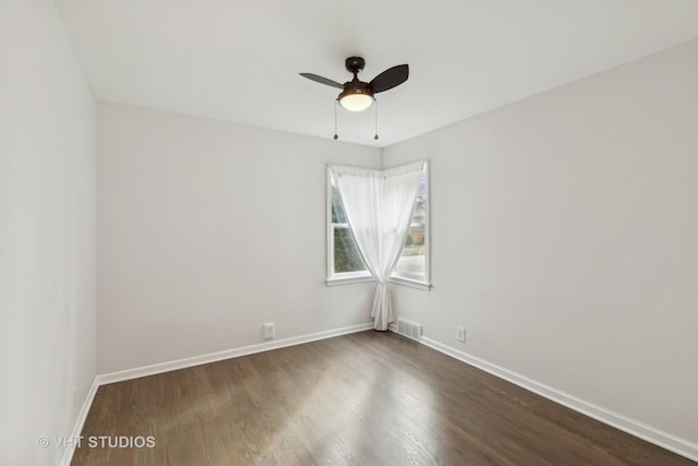 spare room with ceiling fan and dark hardwood / wood-style flooring