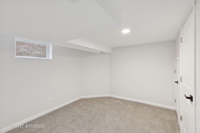 basement featuring light colored carpet