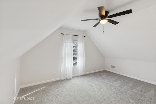 additional living space with lofted ceiling, carpet flooring, and ceiling fan