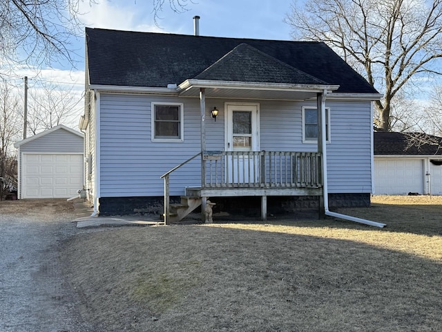 view of front of property with an outbuilding, a garage, and a front yard