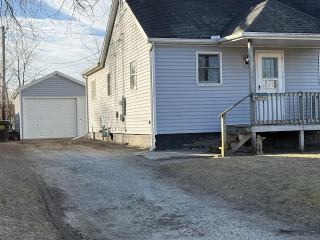 view of side of home with a garage and an outdoor structure