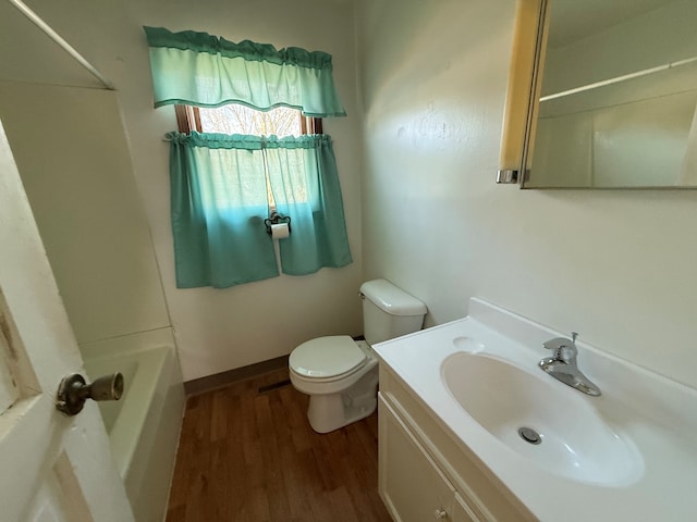 full bathroom with shower / bath combination, vanity, hardwood / wood-style floors, and toilet