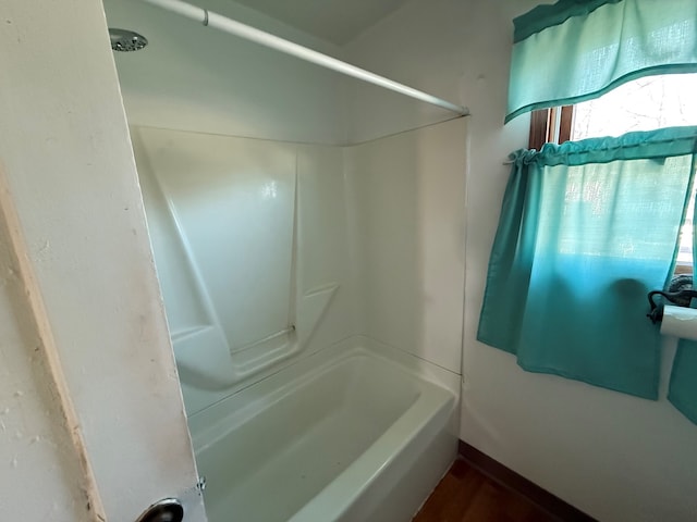 bathroom featuring hardwood / wood-style floors and a shower