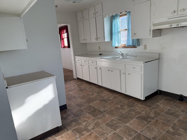 kitchen featuring white cabinetry, sink, and plenty of natural light