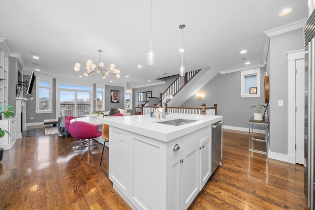 kitchen featuring sink, dark hardwood / wood-style floors, white cabinets, and a center island with sink