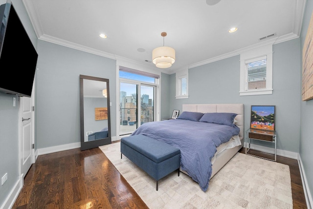 bedroom featuring hardwood / wood-style floors, crown molding, access to outside, and multiple windows