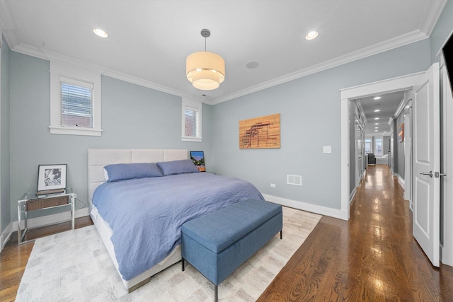 bedroom featuring hardwood / wood-style flooring and crown molding