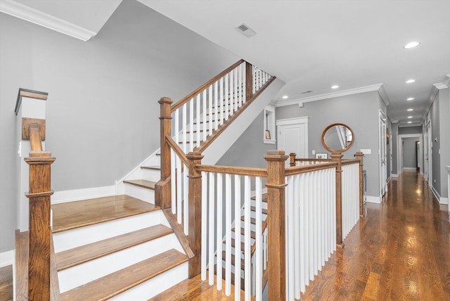 stairs featuring crown molding and wood-type flooring