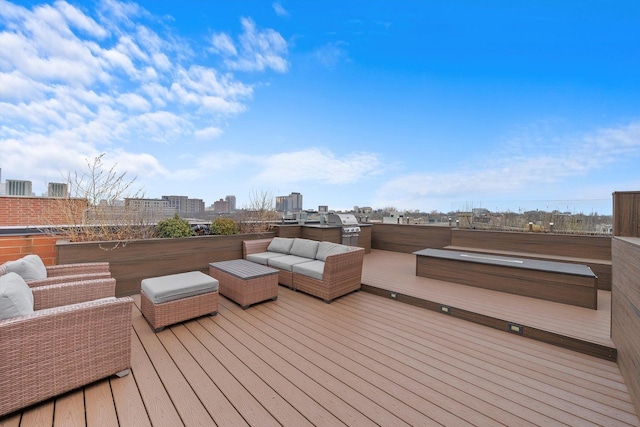 deck featuring an outdoor living space and a grill