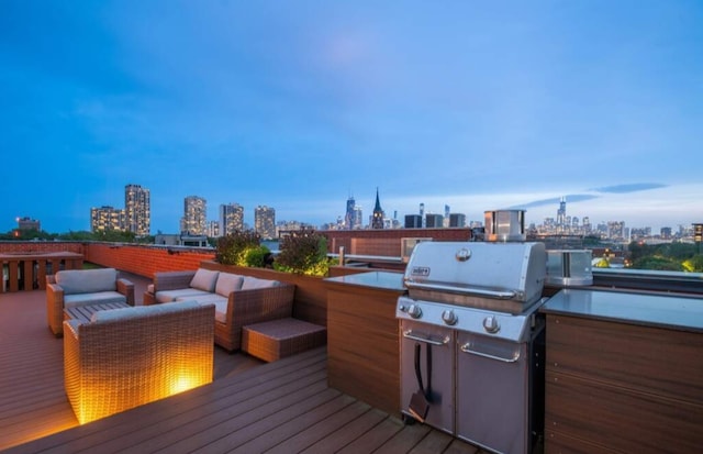 wooden deck featuring outdoor lounge area and a grill