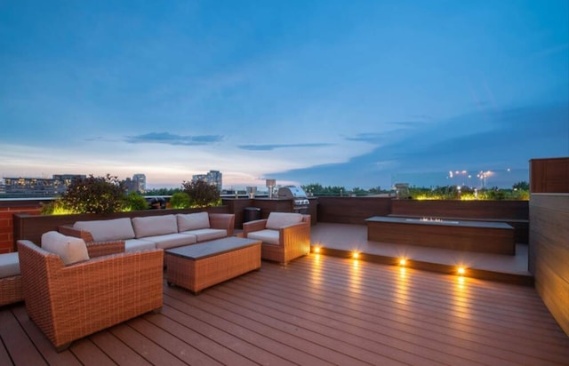 deck at dusk with an outdoor hangout area