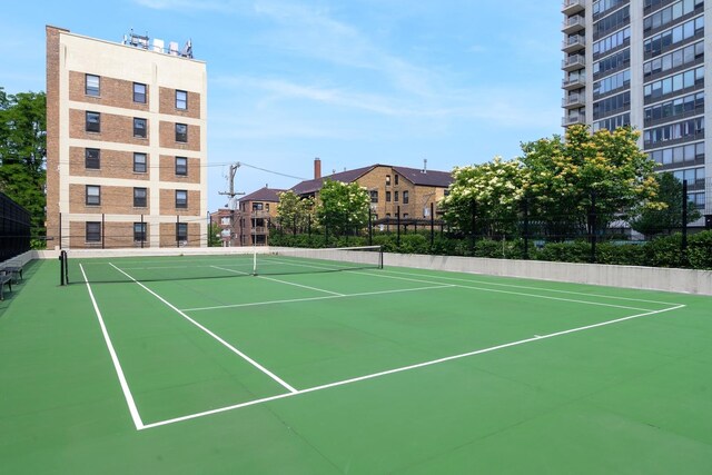 view of tennis court featuring basketball hoop