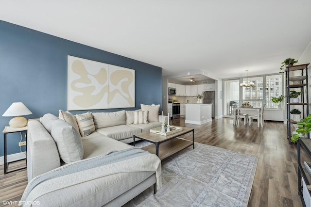 living room featuring hardwood / wood-style flooring and an inviting chandelier