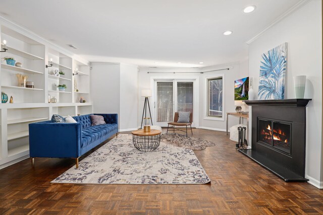 living room with dark parquet flooring and ornamental molding