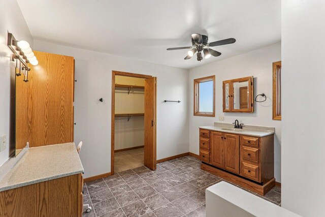 4204 E Dr, Wonder Lake, IL 60097 - full bathroom with vanity, ceiling fan, and a walk in closet
