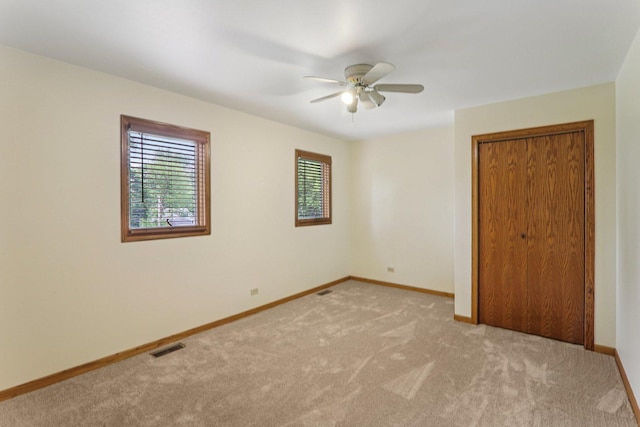 4204 E Dr, Wonder Lake, IL 60097 - unfurnished bedroom with light carpet, a closet, and a ceiling fan