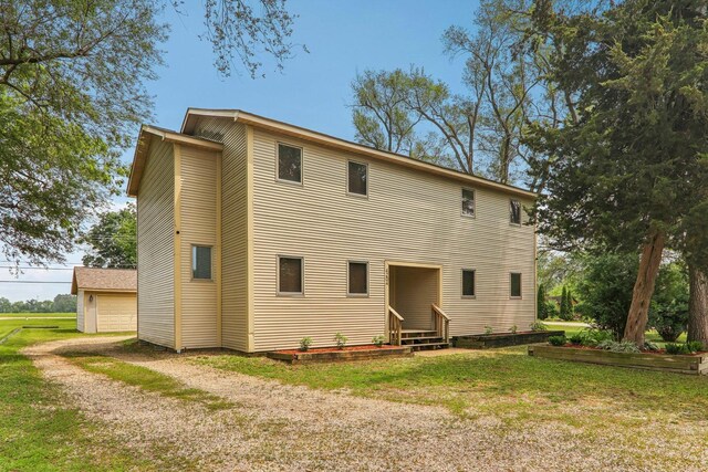 4204 E Dr, Wonder Lake, IL 60097 - rear view of property featuring entry steps and a lawn