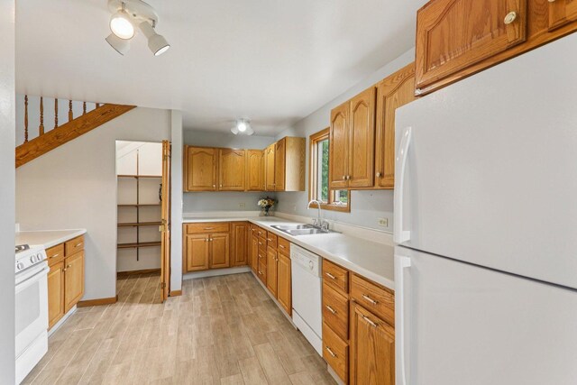 4204 E Dr, Wonder Lake, IL 60097 - kitchen with white appliances, light wood-style floors, light countertops, and brown cabinetry