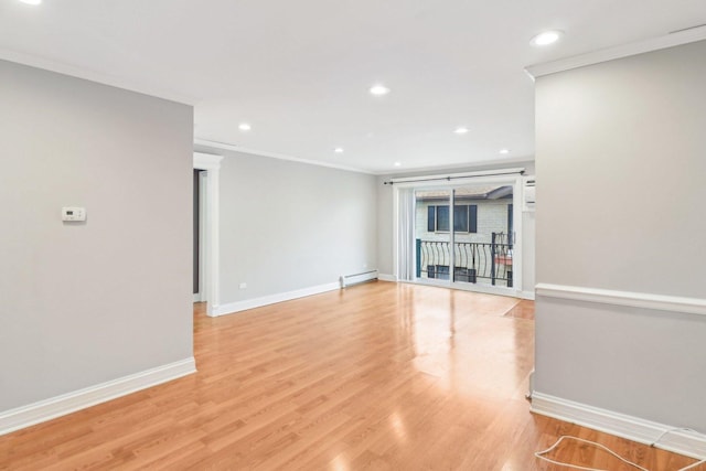 unfurnished living room featuring crown molding, a baseboard heating unit, and light hardwood / wood-style floors