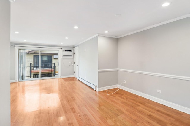 spare room with a wall mounted air conditioner, crown molding, light wood-type flooring, and baseboard heating