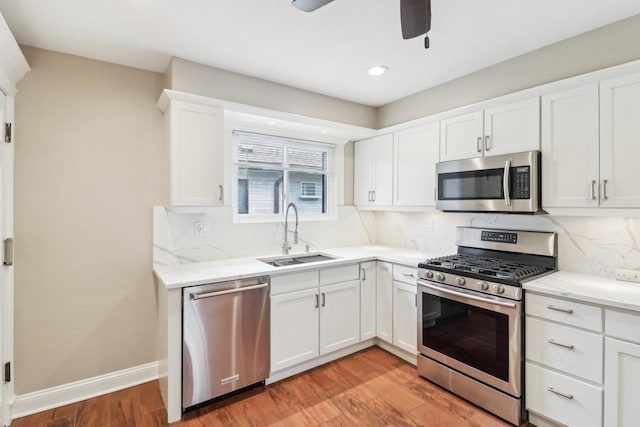 kitchen featuring sink, stainless steel appliances, and white cabinets