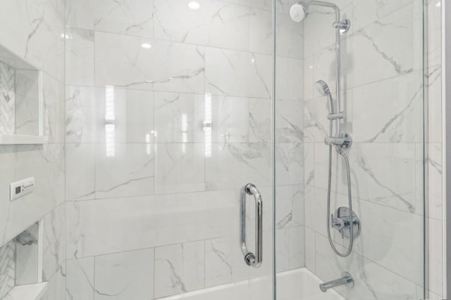 bathroom featuring shower / bath combination with glass door