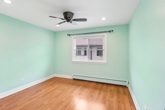 unfurnished room with a baseboard heating unit, ceiling fan, and light hardwood / wood-style floors