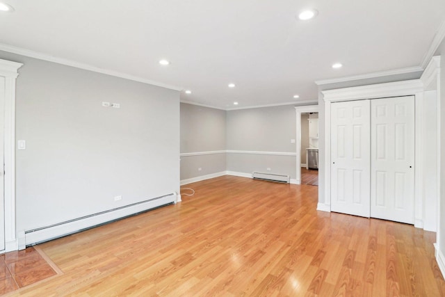 interior space featuring a baseboard heating unit, crown molding, and light hardwood / wood-style floors