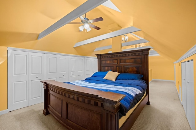 bedroom featuring light colored carpet, lofted ceiling with skylight, and ceiling fan