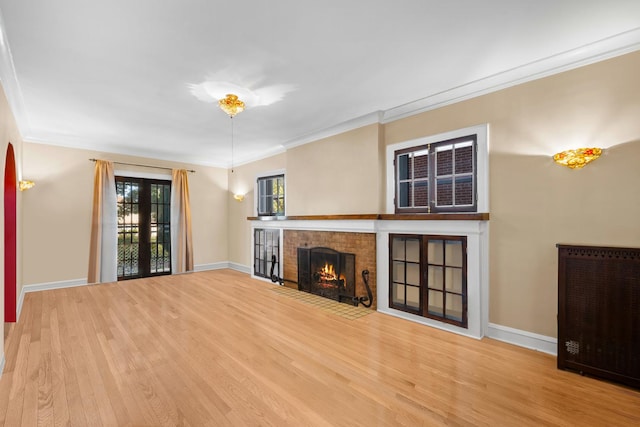 unfurnished living room featuring hardwood / wood-style flooring, a fireplace, and ornamental molding