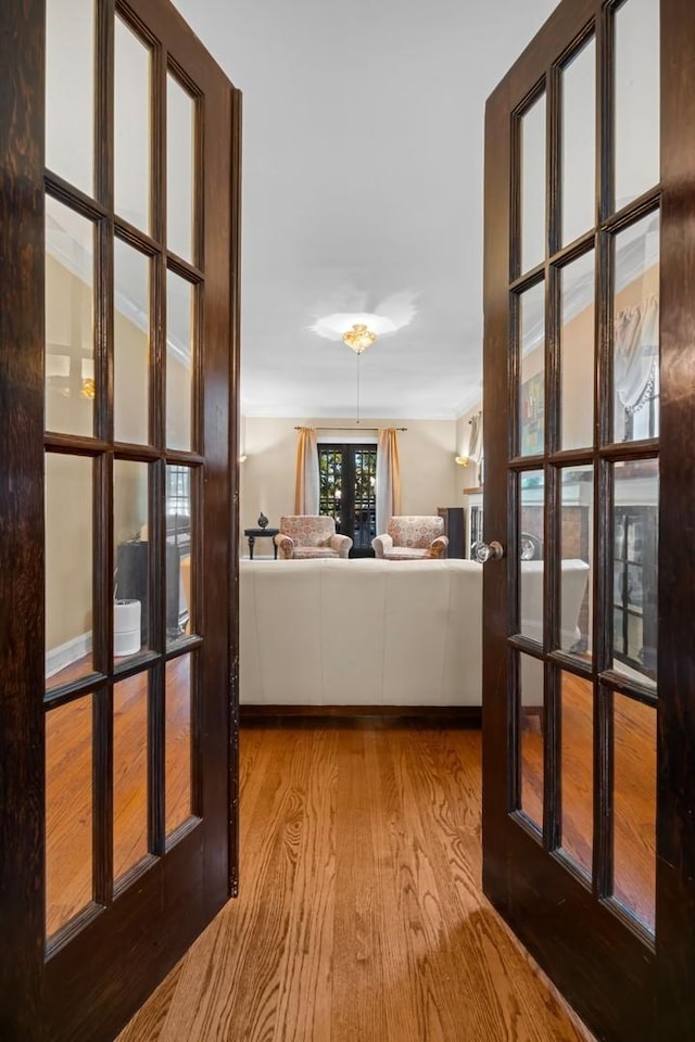 hall featuring light hardwood / wood-style flooring and french doors