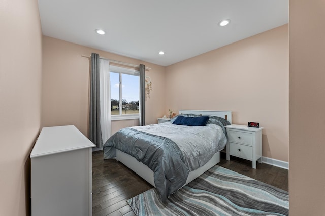 bedroom with dark hardwood / wood-style flooring