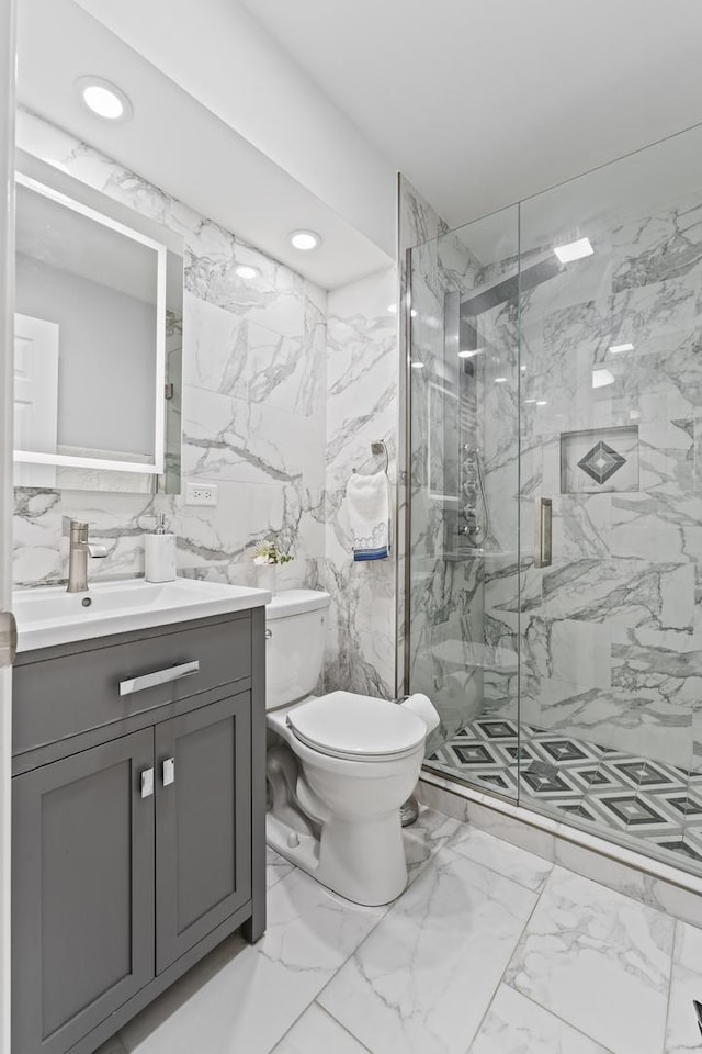 bathroom featuring vanity, toilet, and an enclosed shower