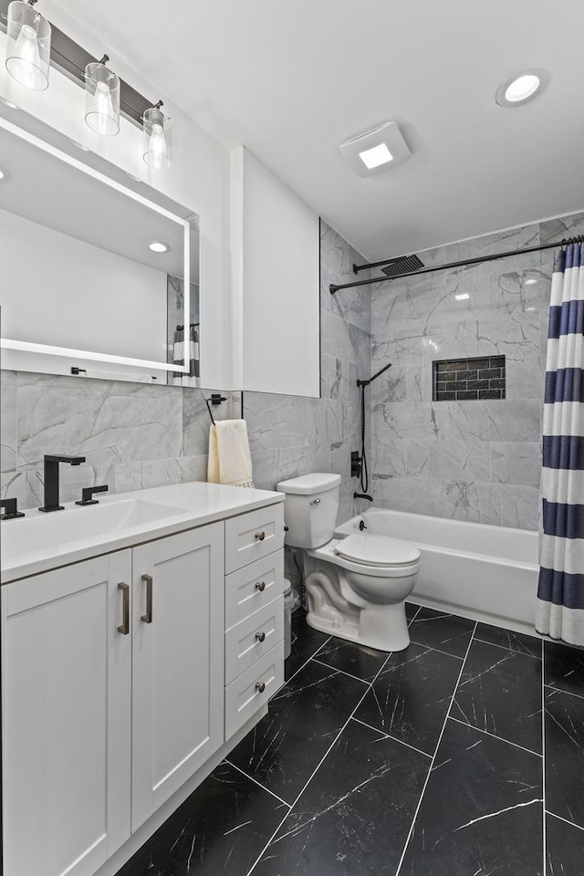 full bathroom featuring toilet, vanity, shower / bathtub combination with curtain, and tile walls