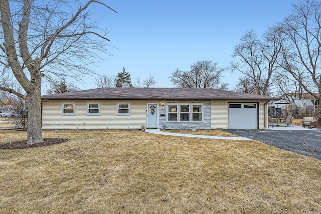 ranch-style house with driveway, a garage, fence, and a front lawn