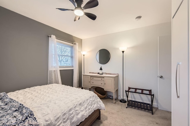 bedroom featuring baseboards, a ceiling fan, and light colored carpet