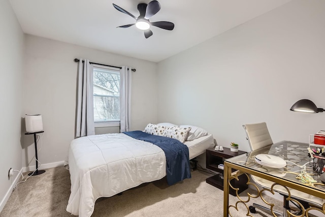 bedroom featuring a ceiling fan, light carpet, and baseboards