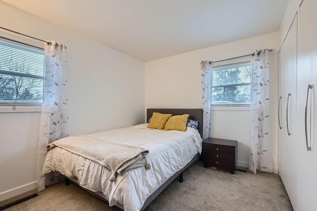 carpeted bedroom with baseboards