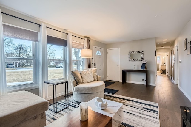 living room featuring wood-type flooring and baseboards