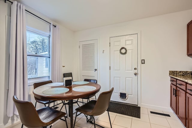 dining room with visible vents, baseboards, and light tile patterned floors