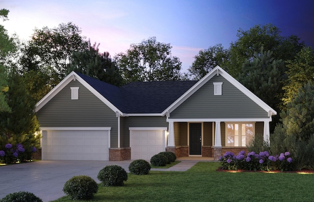 view of front of property featuring a garage, a yard, and covered porch