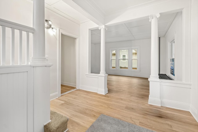 hall featuring ornate columns, hardwood / wood-style floors, and beam ceiling