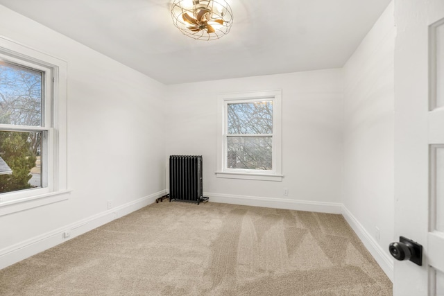 carpeted empty room with radiator