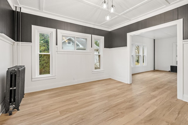 unfurnished living room featuring radiator and light hardwood / wood-style flooring