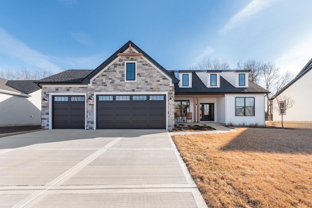 view of front of home featuring a garage and a front yard