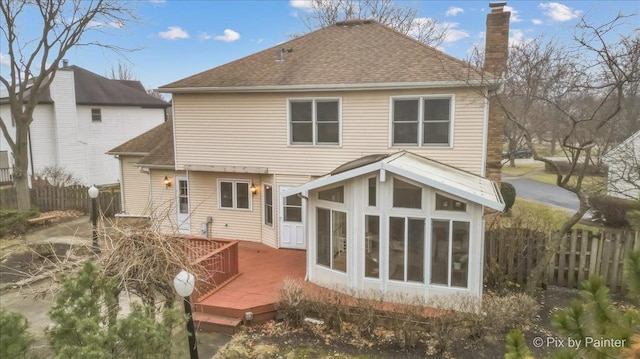 back of house featuring a sunroom and a deck