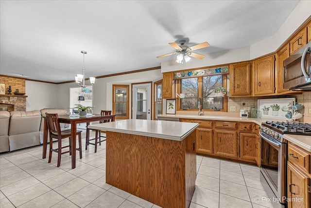 kitchen featuring light tile patterned flooring, a kitchen island, pendant lighting, decorative backsplash, and stainless steel appliances