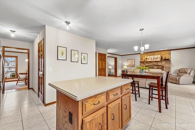 kitchen featuring an inviting chandelier, decorative light fixtures, a center island, and light tile patterned floors