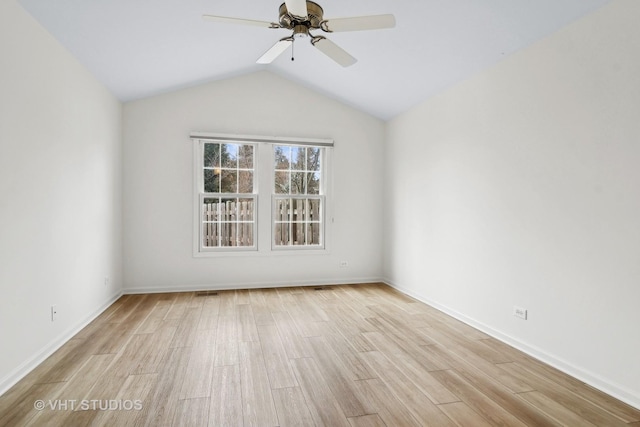 empty room with vaulted ceiling, ceiling fan, and light hardwood / wood-style floors