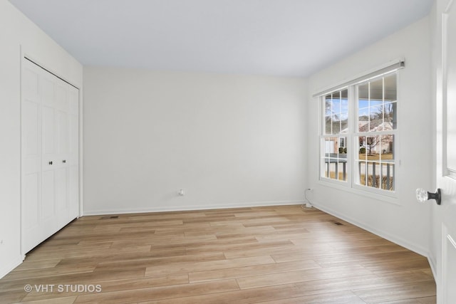 spare room with light hardwood / wood-style floors